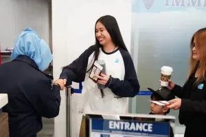 An immigration official greets Nene Royal at Phuket International Airport on Wednesday as she was leaving for the United States to perform in the pivotal Live Shows of America's…