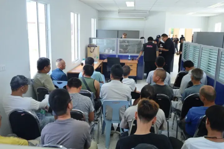 The illegal foreign workers, mostly Chinese, await questioning at the Internal Security Operation Command provincial office after being arrested at a construction site in Muang…
