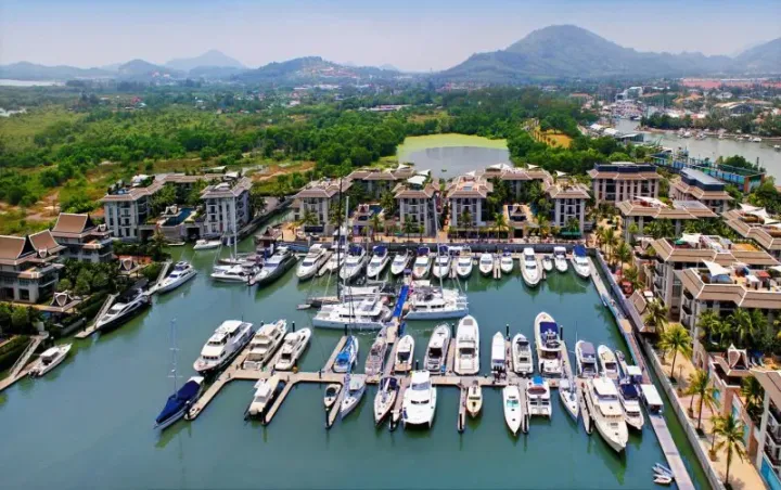 Yachts docked at a marina in Phuket, where real estate analysts expect a boom in the upscale property segment as international buyers eye the island as an asset diversification…