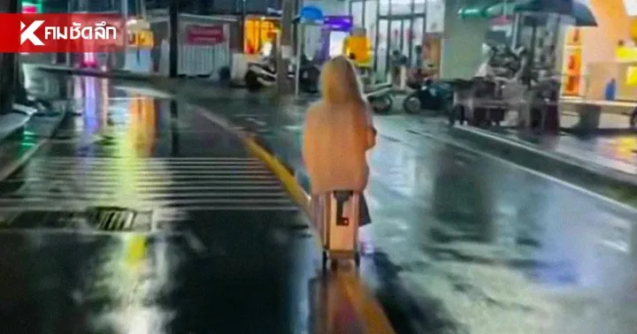 Foreign tourist rides electric suitcase along Patong road in heavy rain